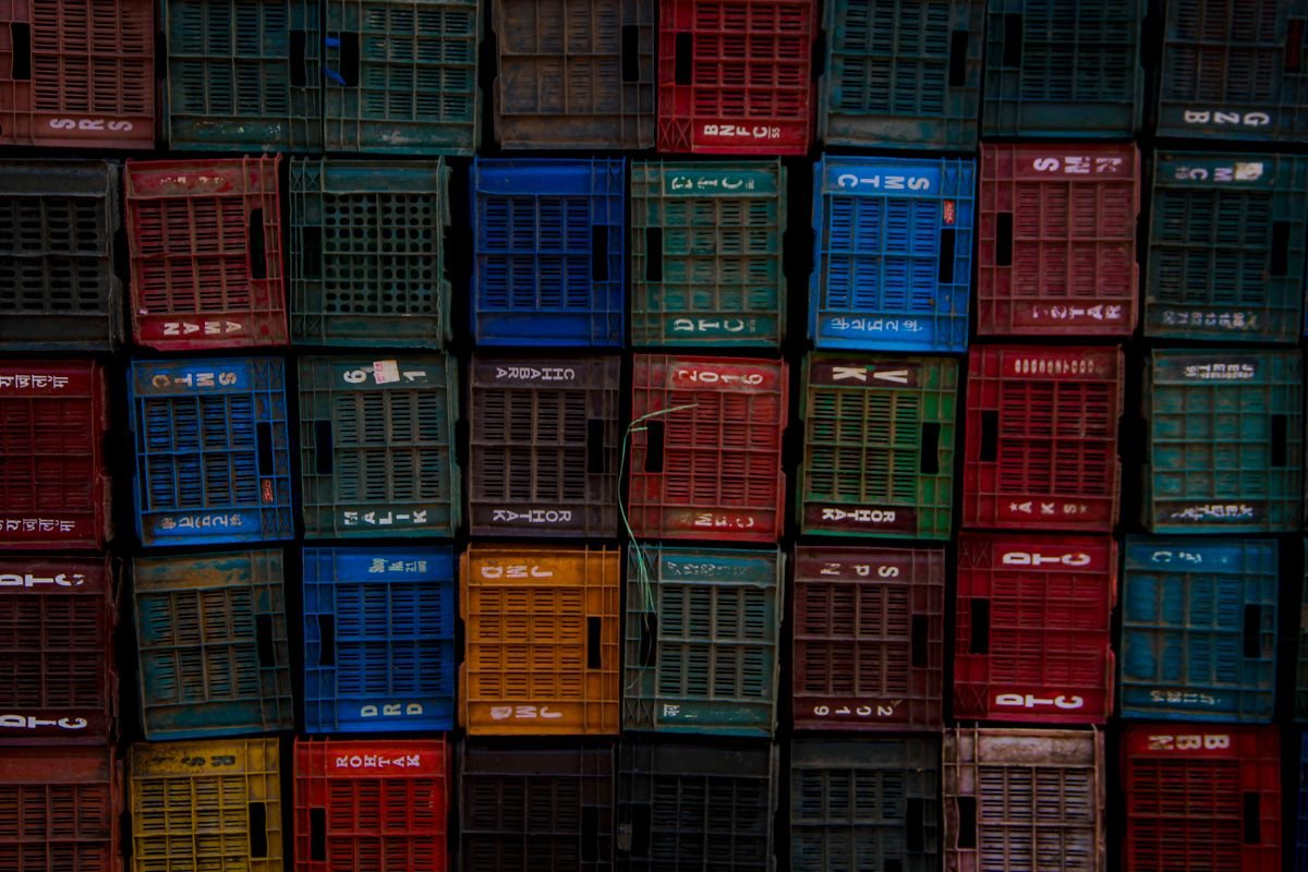 Stacked plastic crates in several colours